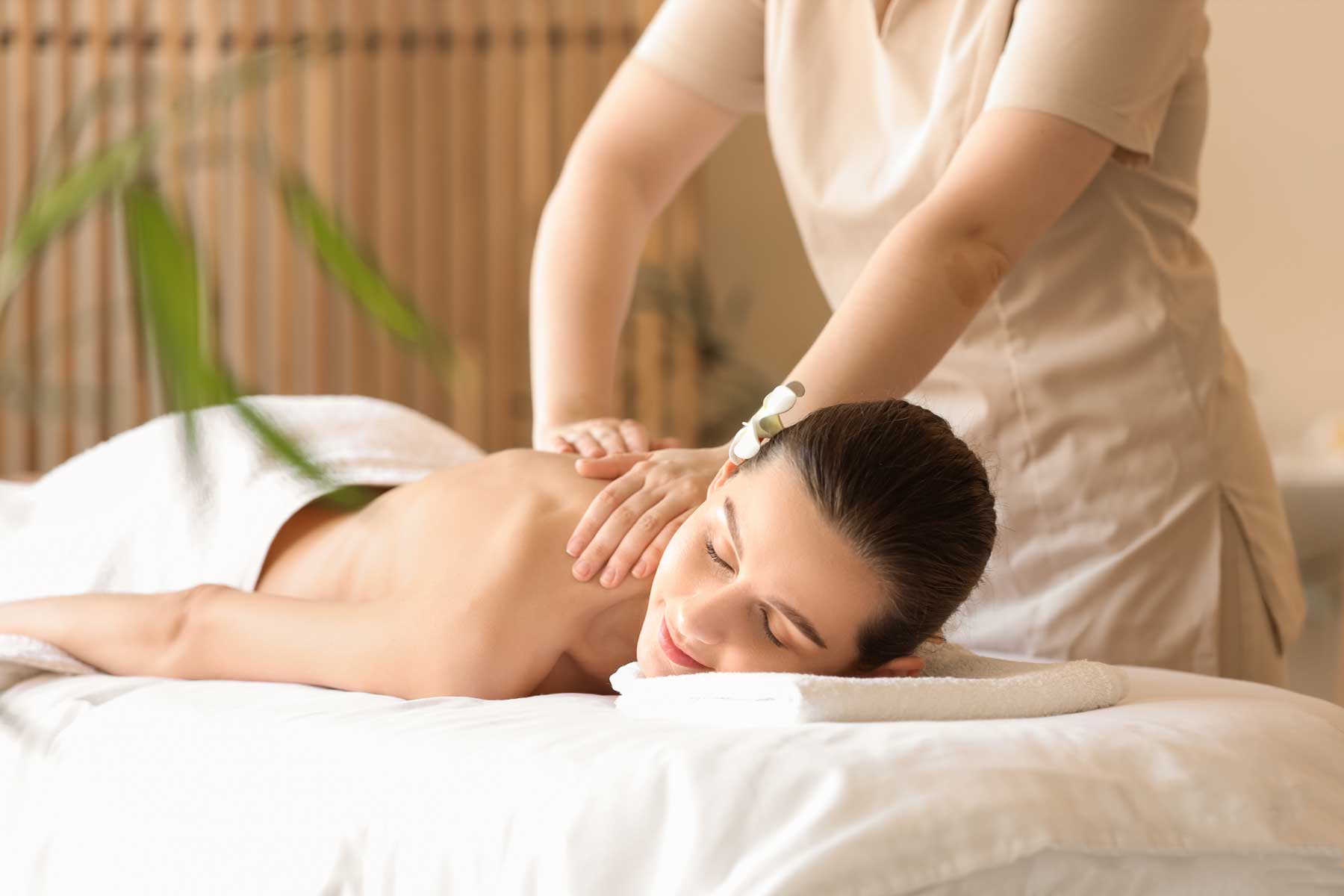 Therapist performing a relaxing back massage